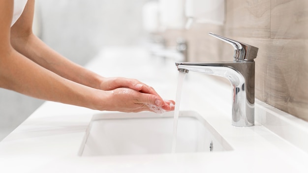 Free photo person washing hands with soap