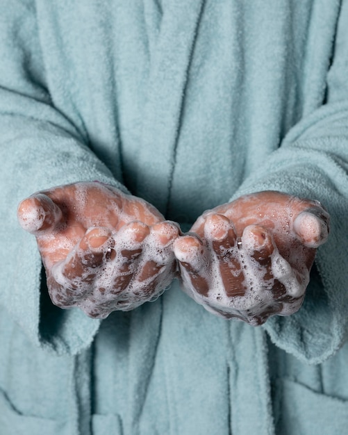 Free photo person washing hands with soap