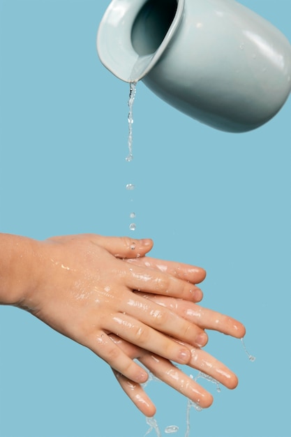 Free photo person washing hands with water