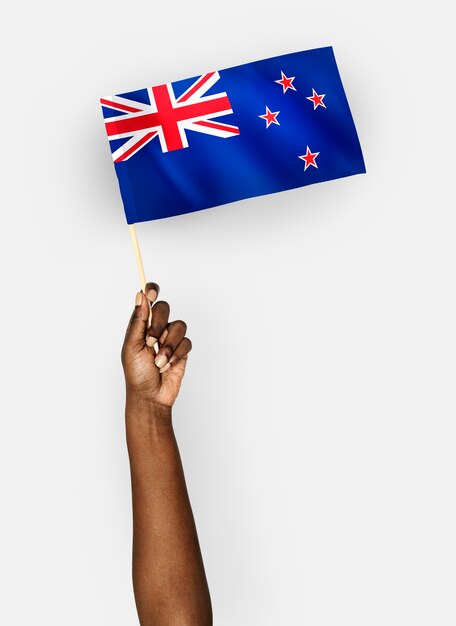 Person waving the flag of New Zealand