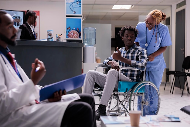 Person with chronic disability in waiting room at health center facility, wheelchair user waiting to attend checkup appointment. Man with physcal impairment doing consultation at medical clinic.