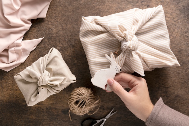 Free photo person with festive wrapped christmas gift