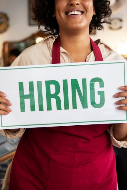 Free Photo person with hiring sign by the window