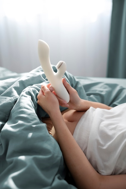 Person with sexual toy in bed