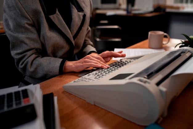 Free Photo person working at a desk in vintage 90's style office