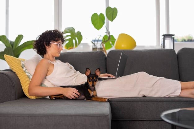 Free Photo person working from home with pet dog