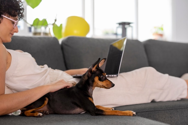 Free Photo person working from home with pet dog