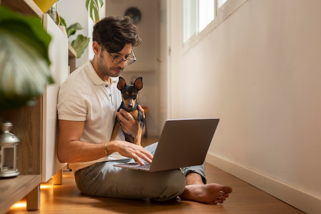 Free photo person working from home with pet dog