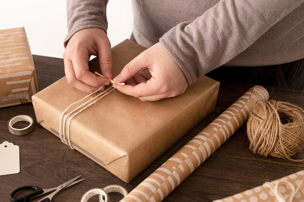 Free Photo person wrapping a christmas gift