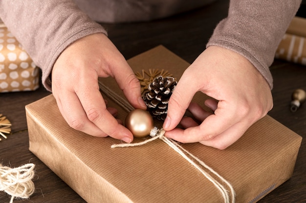 Free photo person wrapping a christmas gift