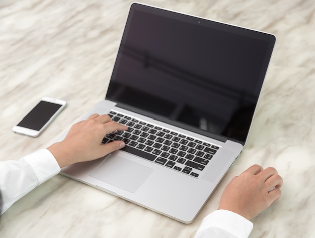 Free Photo person writing with one hand and the other touching a mouse