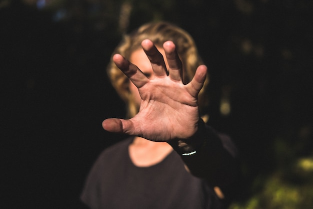 A persons palm of a hand covering his face