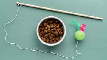 Free photo pet accessories still life with toy and food bowl