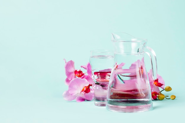 Petals of orchids with jug of water