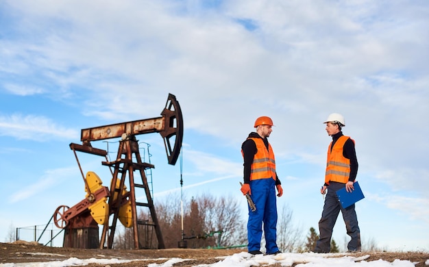 Free photo petroleum operators talking at oil field