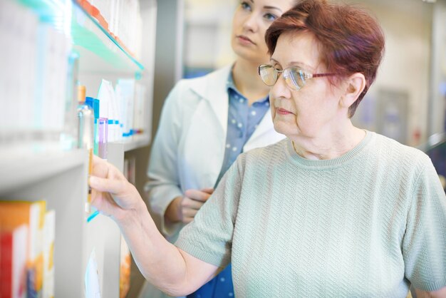 Pharmacist helping senior woman with prescription