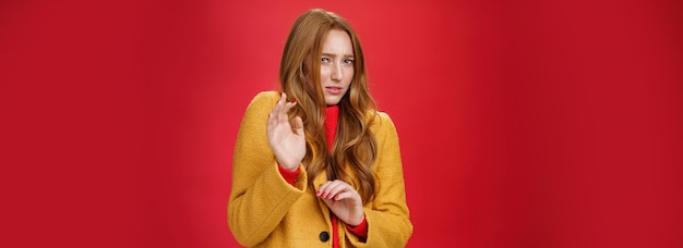 Free photo phew disgusting take it away unsatisfied intense and displeased cute redhead woman in yellow coat ra