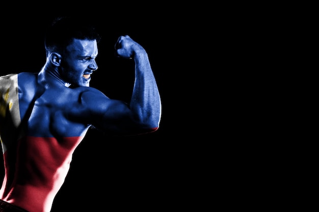 Philippines flag on handsome young muscular man black background