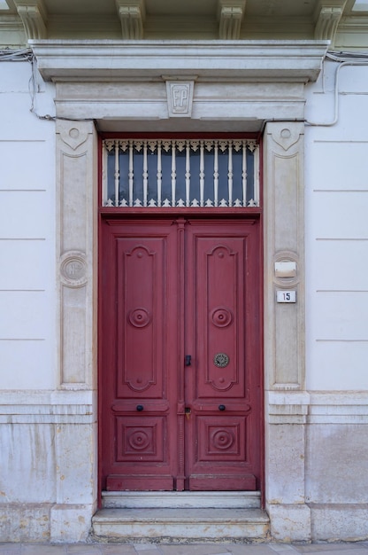 Photo of antique red wooden door in a classic building