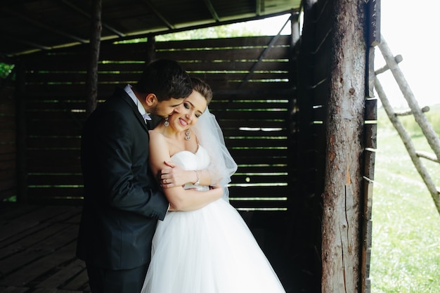 Free photo photo of beautiful couple on nature in wooden hut