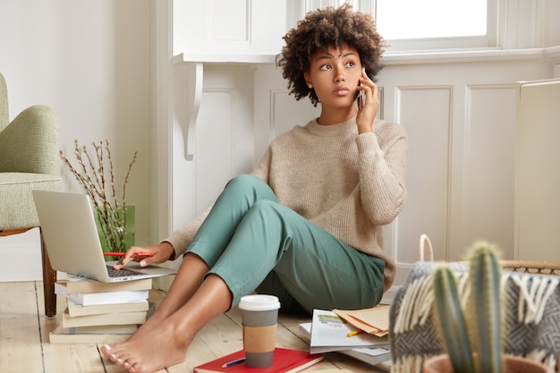 Photo of black woman has telephone conversation