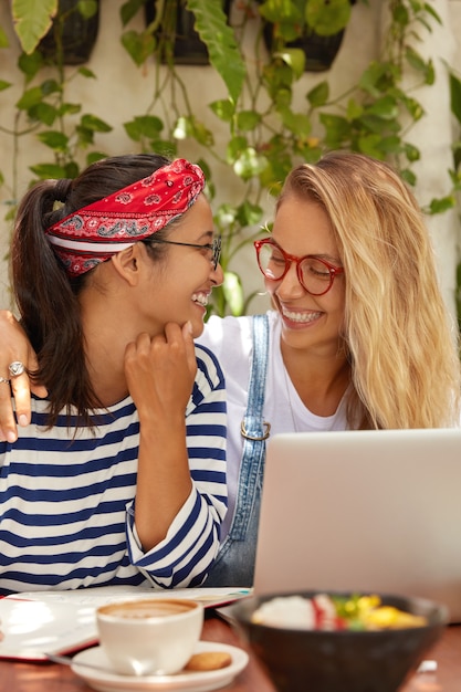 Photo of cheerful two women look with smiles