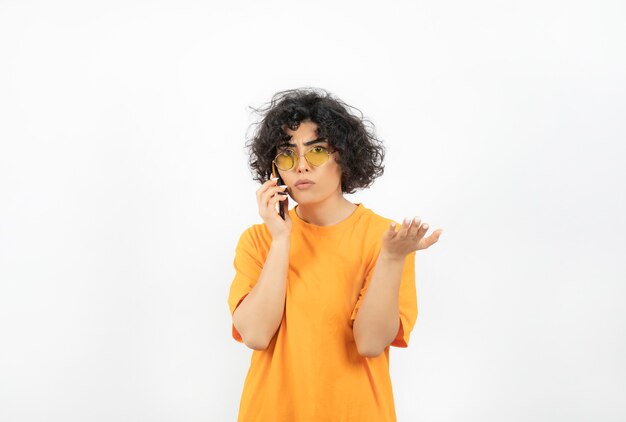 Photo of curly woman talking over phone