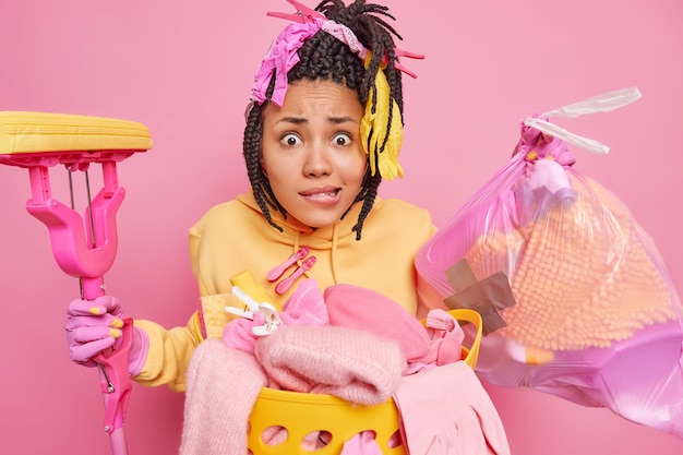 Photo of desperate nervous African American woman carries trash bag