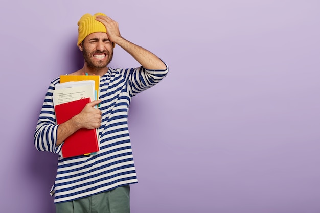 Free photo photo of fatigue student or school teacher holds hand on head