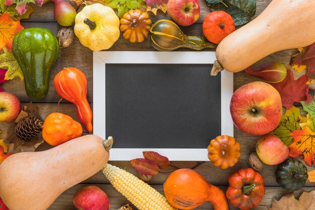 Photo frame between fruits and vegetables