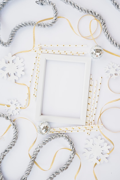 Free photo photo frame between tinsel and ribbons