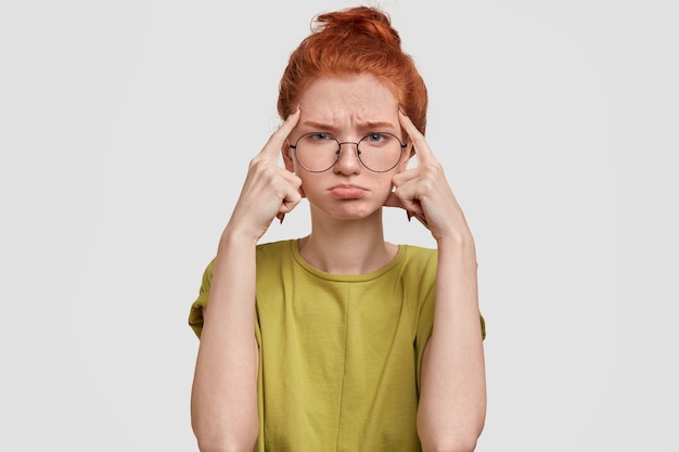 Free Photo photo of gloomy red haired girl has sorrowful expression