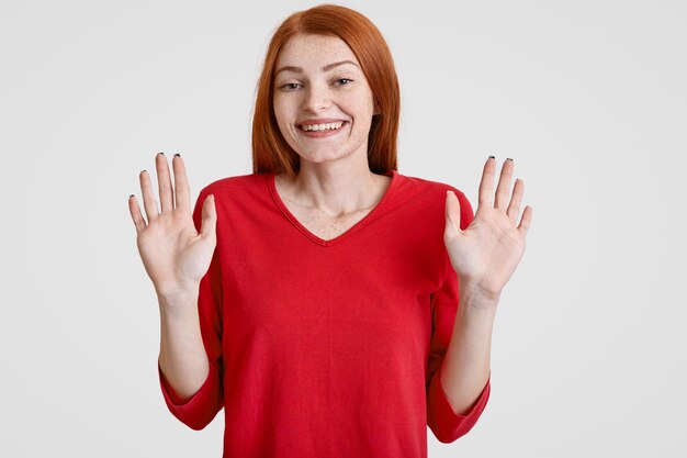 Photo of joyful freckled woman with long red hair