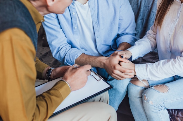 Free photo photo of people hands holding on meeting with psychologist at home