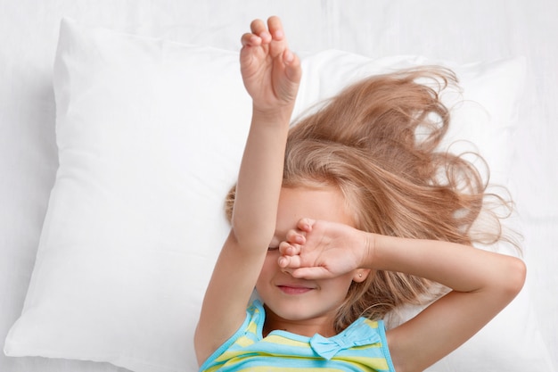 Free photo photo of small adorable cute child covers eyes