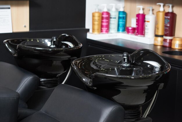 Photo of two black ceramical hair sinks standing in beaty salon