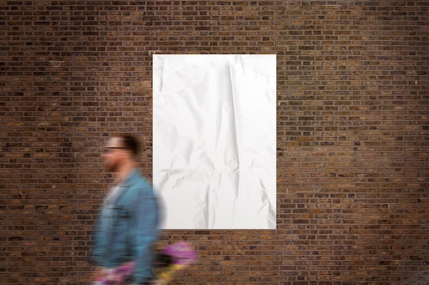 Photo of a white poster on a brick wall with a walking man