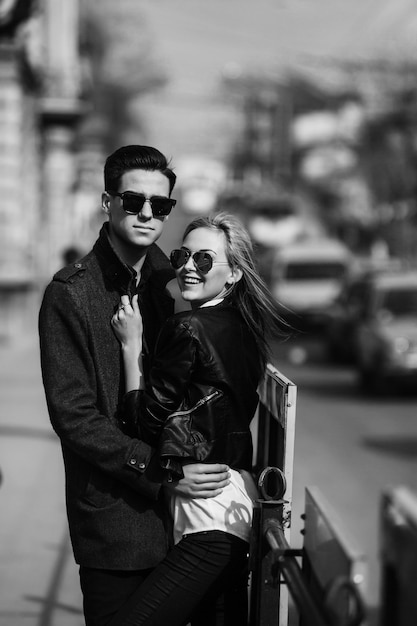 Photo of a young beautiful couple on busy city street