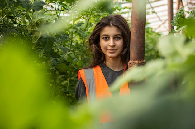 Photo of young beautiful lady at the greenhouse