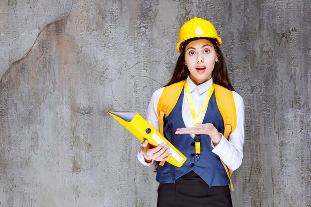 Photo of young engineer in hardhat standing and posing. High quality photo