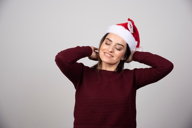 Photo of young woman in Christmas hat posing .