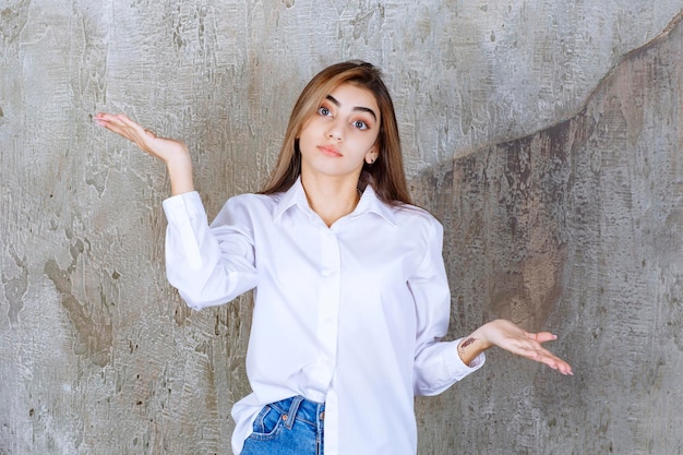 Free Photo photo of young woman in white blouse standing and looking. high quality photo