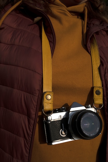 Free photo photographer in the cherry coat and mustard t-shirt with camera