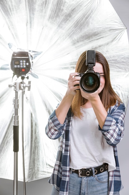 Free photo photographer holding a professional camera