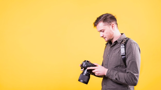 Photographer looking at camera screen 