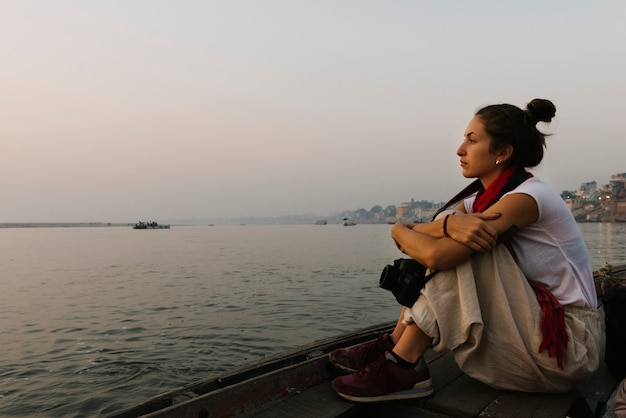 Free photo photographer sitting on a boat on the river ganges