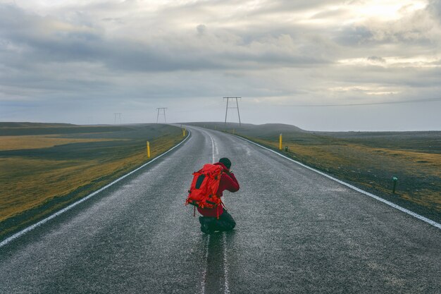 Photographer taking a photo on the road.