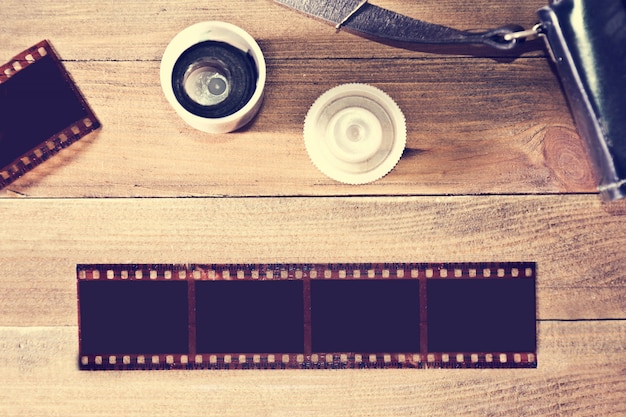 Free photo photographic film on wooden background.