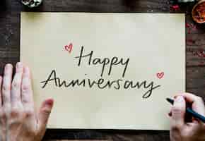 Free photo phrase happy anniversary on a paper