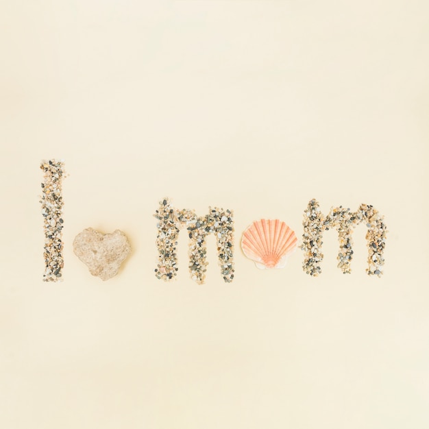 Free photo phrase i love you mom made of sand and shell